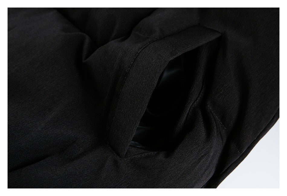 Close-up of a black garment pocket opening with a wide fabric edge.