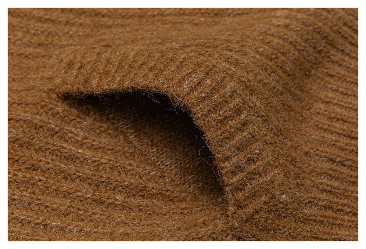 Macro view of the brown garment's fuzzy, textured knit and a folded edge.