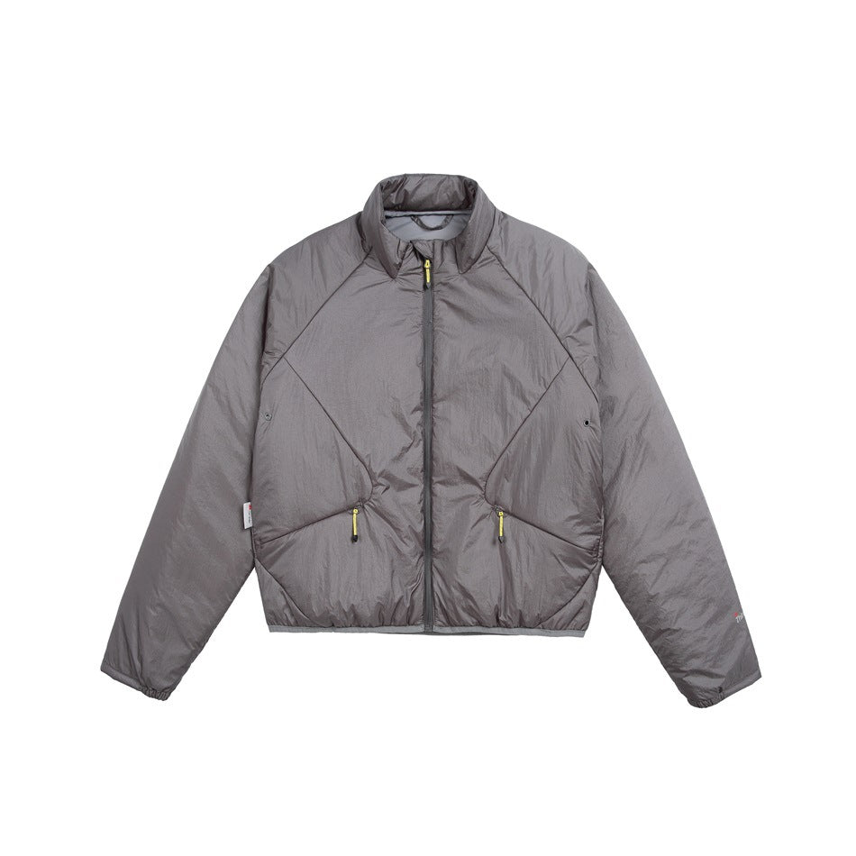 Front view of a gray jacket with a stand collar, full zipper, geometric seams, and two zip pockets with yellow pulls.