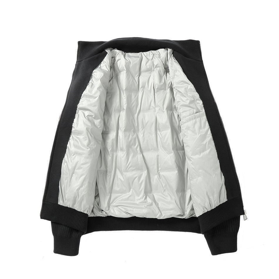 Black zip-up jacket opened flat to show its shiny silver interior lining and ribbed cuffs and hem.