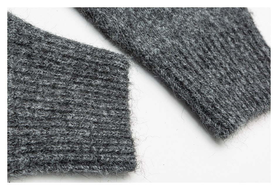 Close-up of two ribbed ends of a charcoal-gray knit garment.