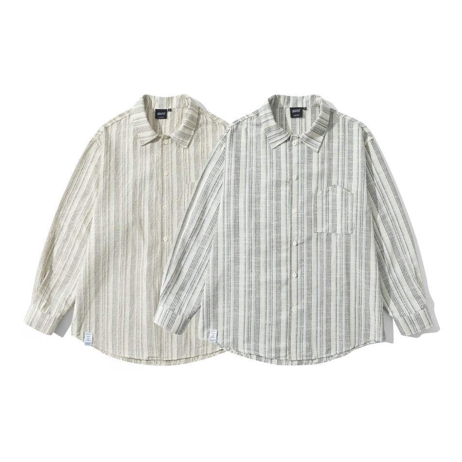 Two long-sleeve button-up shirts with vertical stripes in different light neutral colorways, shown from the front.