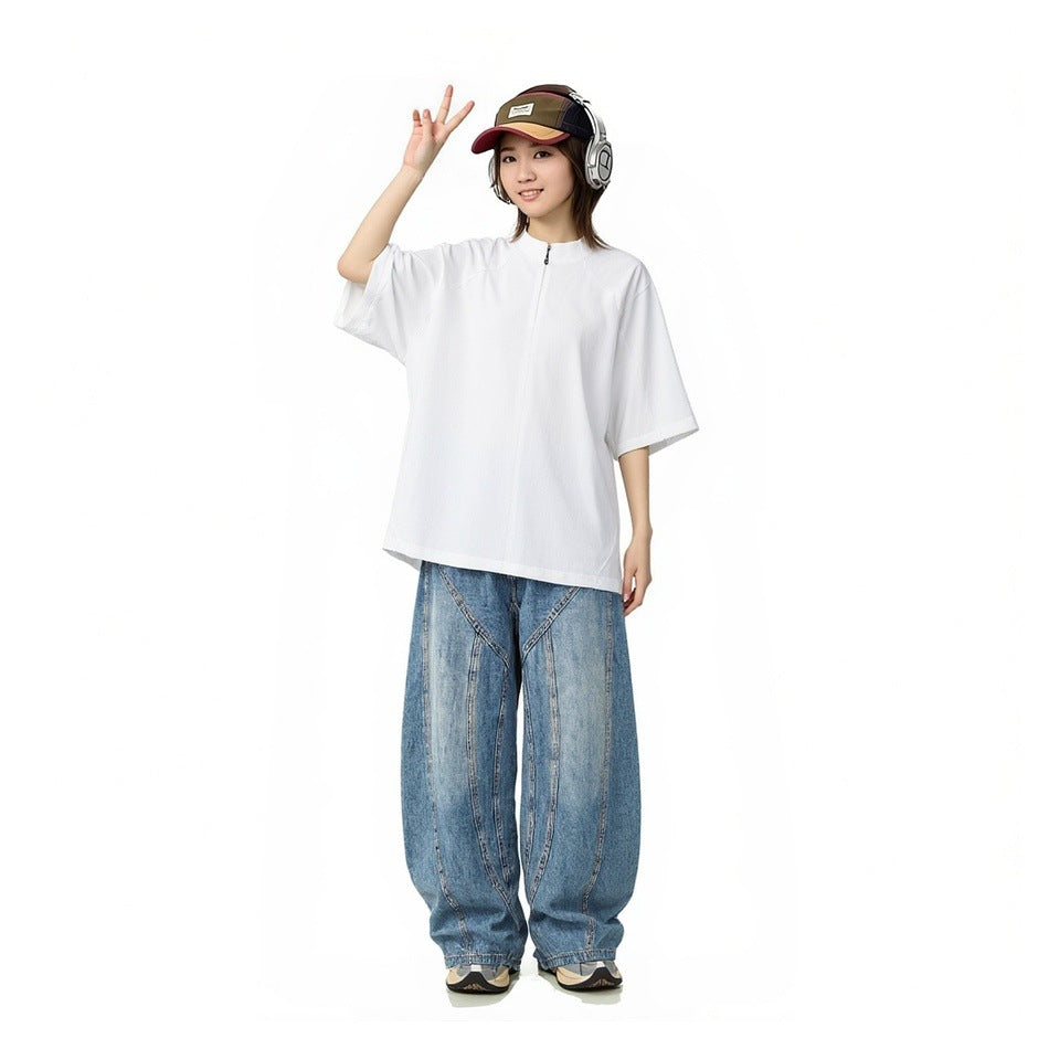 Model wearing white short-sleeve zip stand-collar T-shirt with wide-leg jeans, cap and headphones