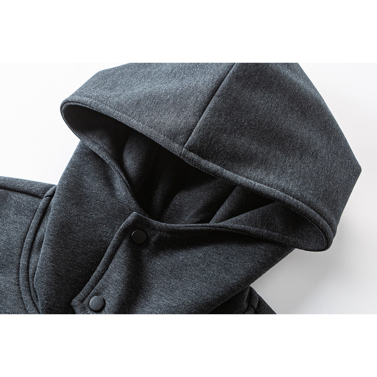 Close-up of a charcoal gray hoodie hood and snap-button placket.