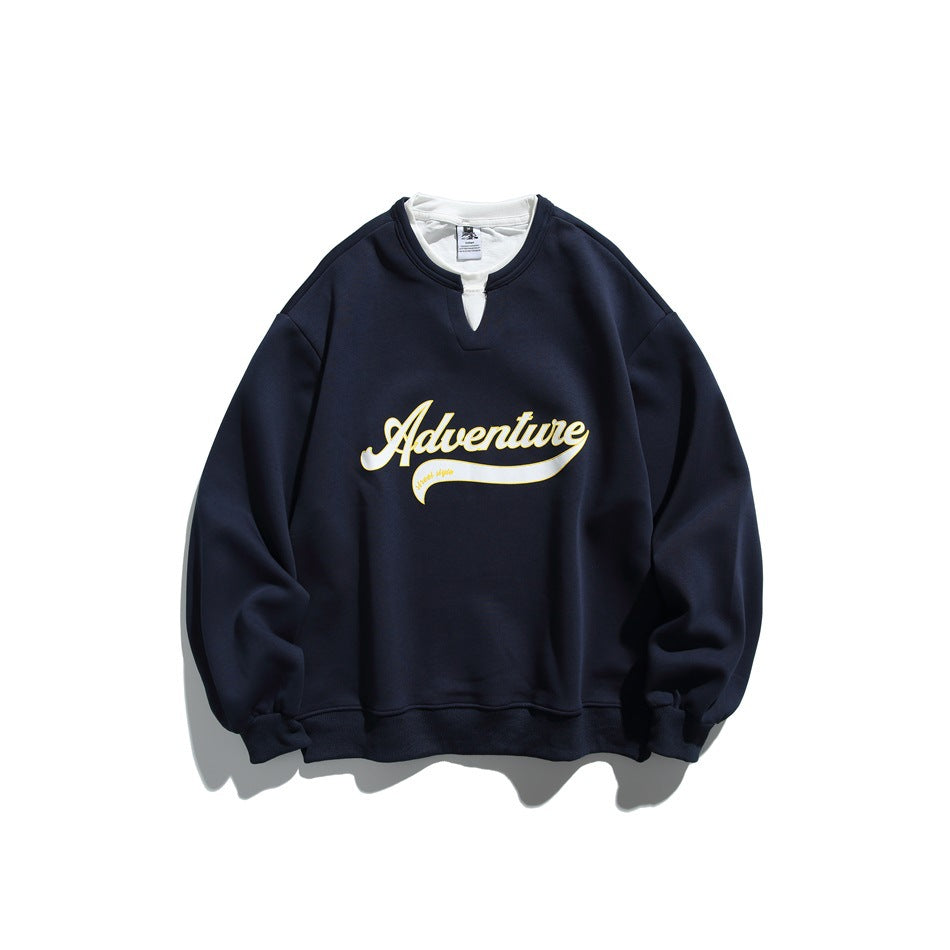 Navy crewneck sweatshirt with white under-collar and yellow-outlined white Adventure script graphic, flat lay