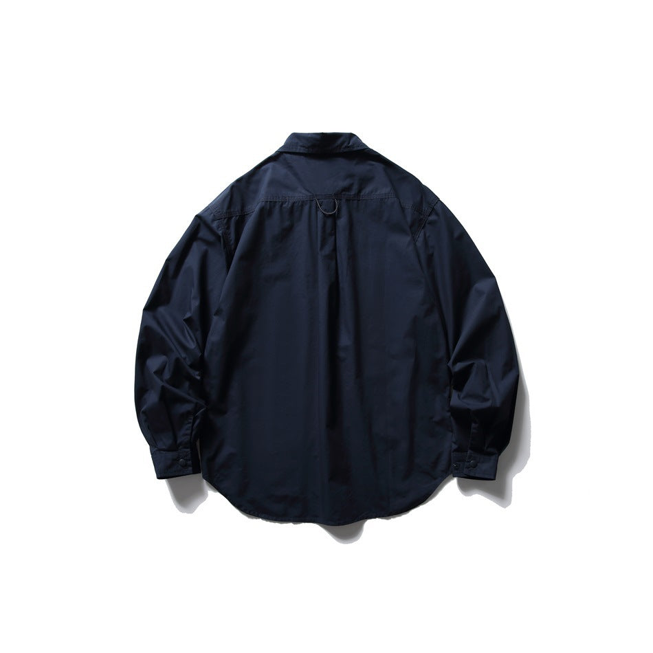 Back view of navy long-sleeve shirt with back yoke seam, small loop at the neck and snap cuffs, flat lay