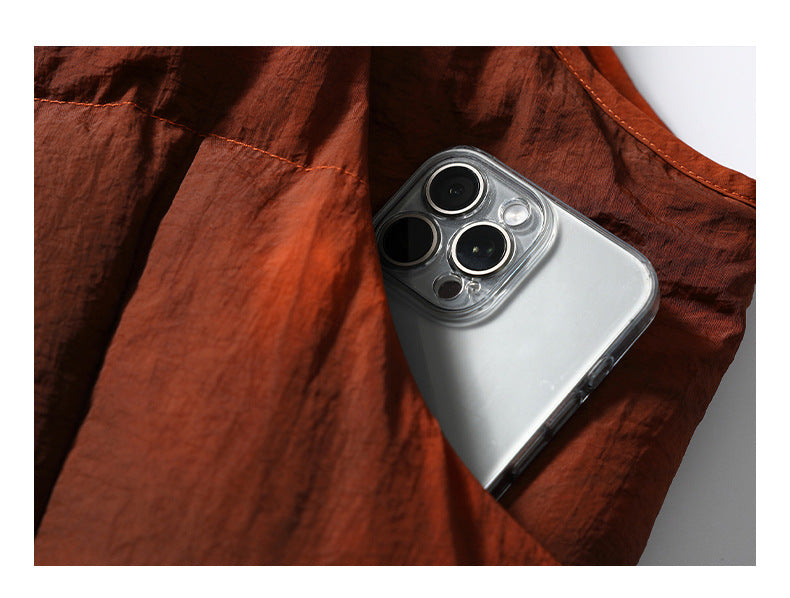 A smartphone tucked into a pocket of the rust-orange padded garment.