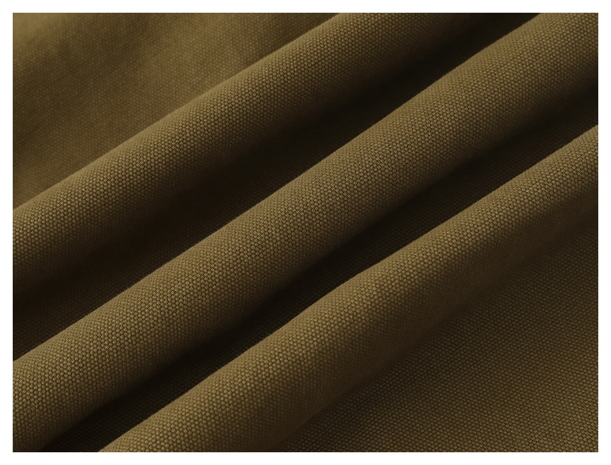 Macro view of the textured olive-brown trouser fabric arranged in diagonal folds.