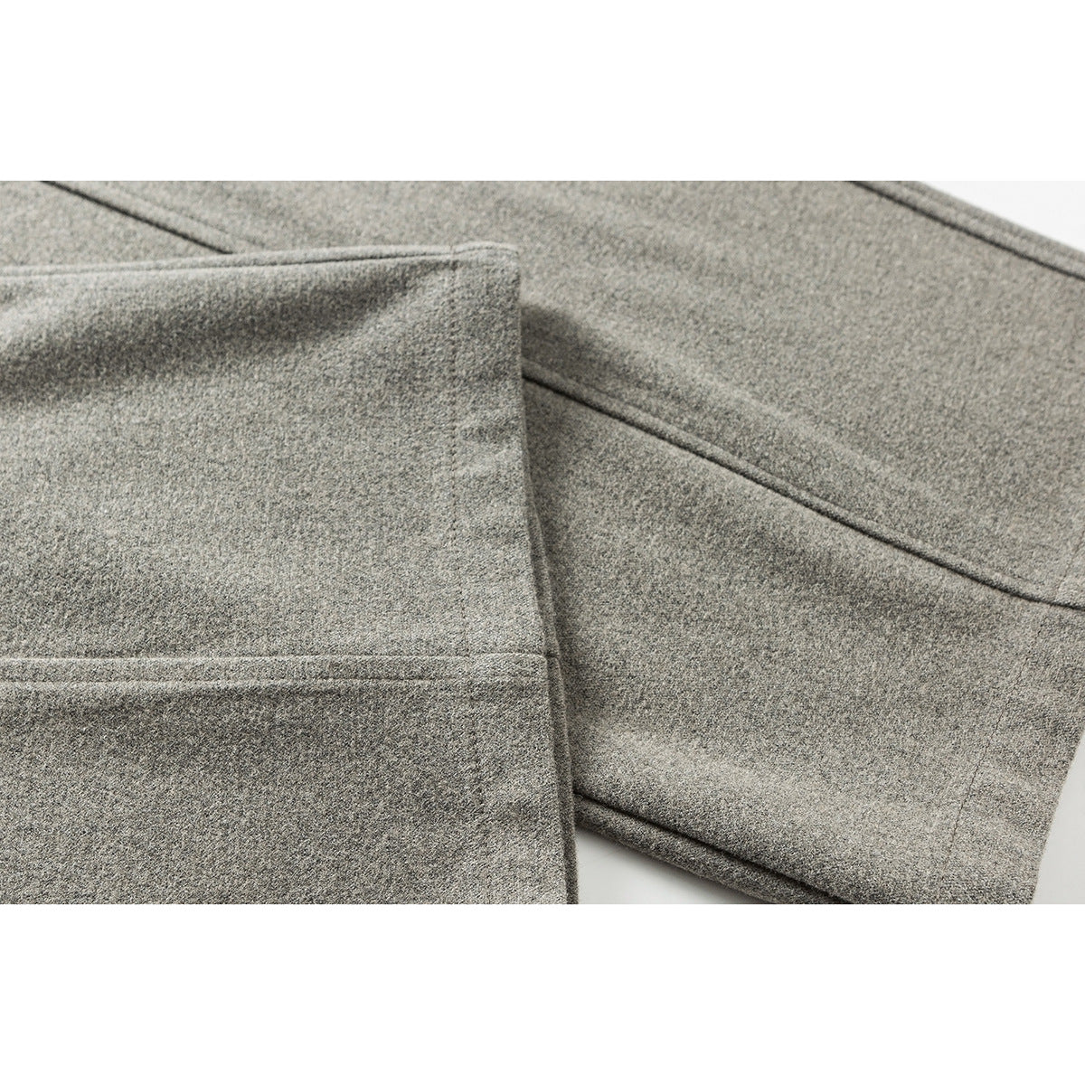 Close-up of gray pants fabric and stitched seams.
