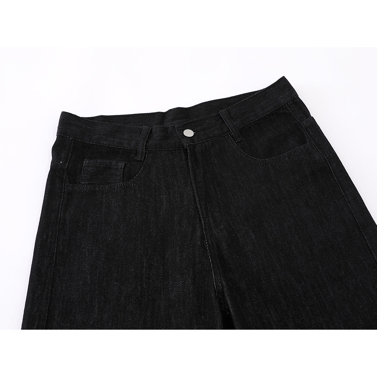 Close-up of black wide-leg jeans showing the front waistband, button, belt loops and pockets.