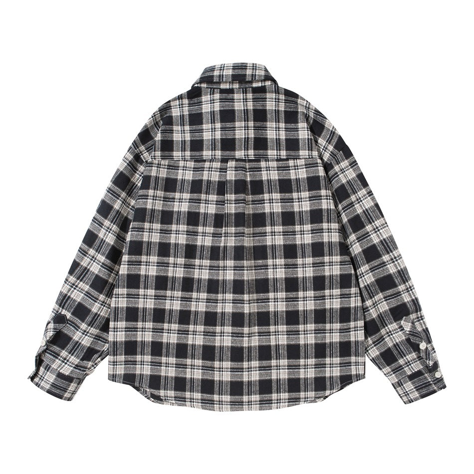 Back view of black and cream plaid long-sleeve shirt with back yoke and buttoned cuffs, flat lay