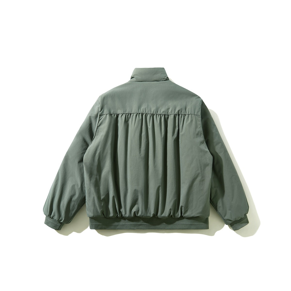 Back view of a sage-green jacket with a high collar, gathered back panel, long sleeves, and ribbed hem and cuffs.
