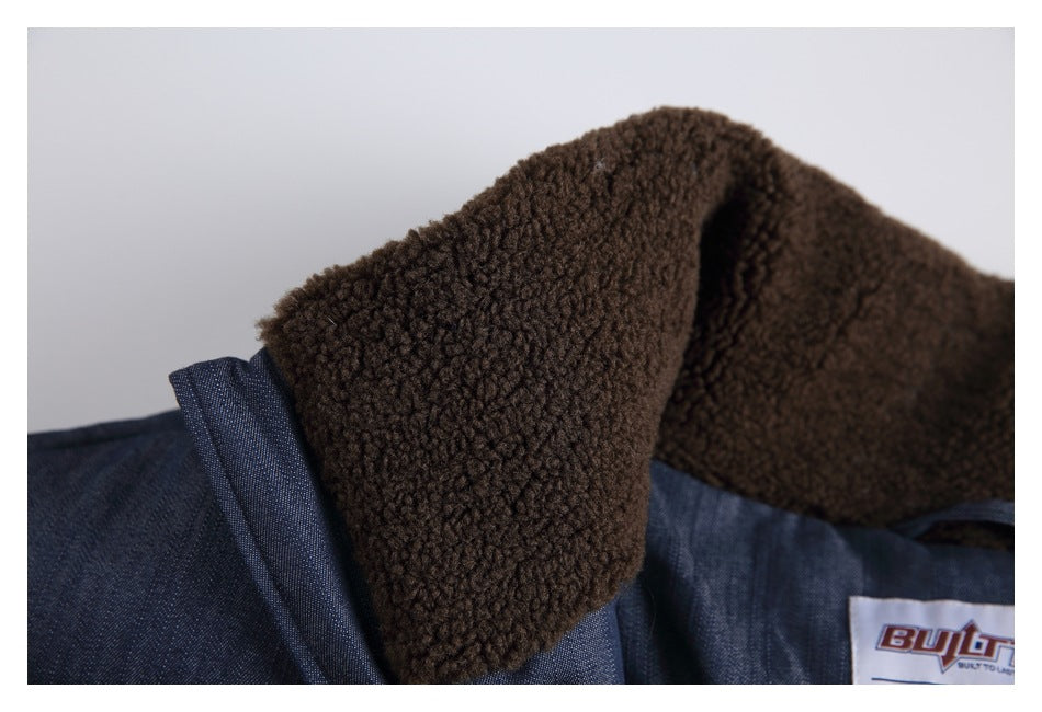 Close-up of a dark blue jacket's brown textured collar lining and sewn-in label.