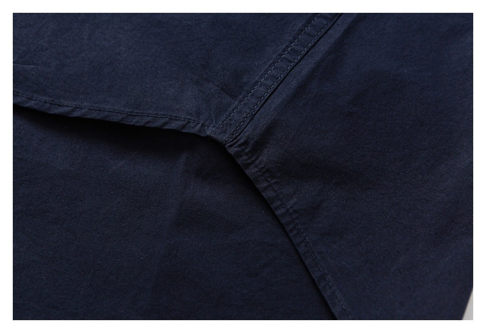 Close-up of a navy garment seam joining two fabric panels.