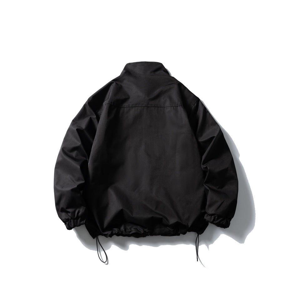Back view of black stand-collar jacket with yoke seam, elastic cuffs and drawstring hem cords