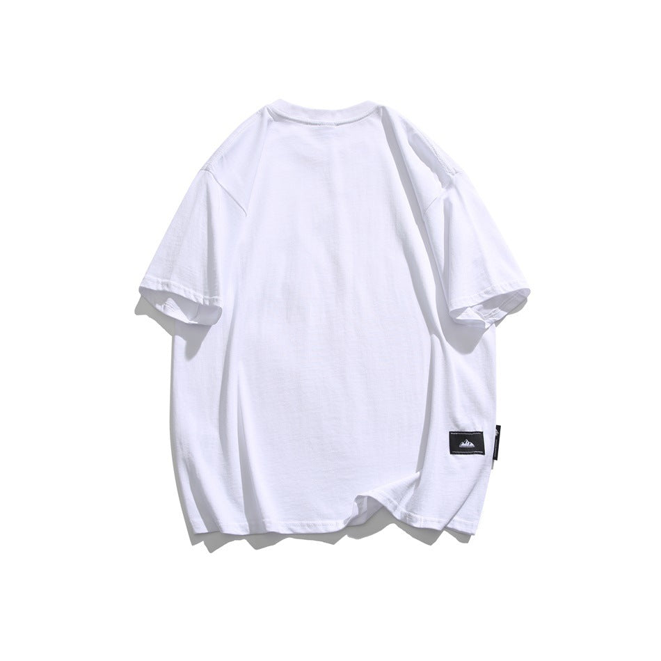 Back view of a plain white oversized short-sleeve T-shirt with a small dark patch near the hem.