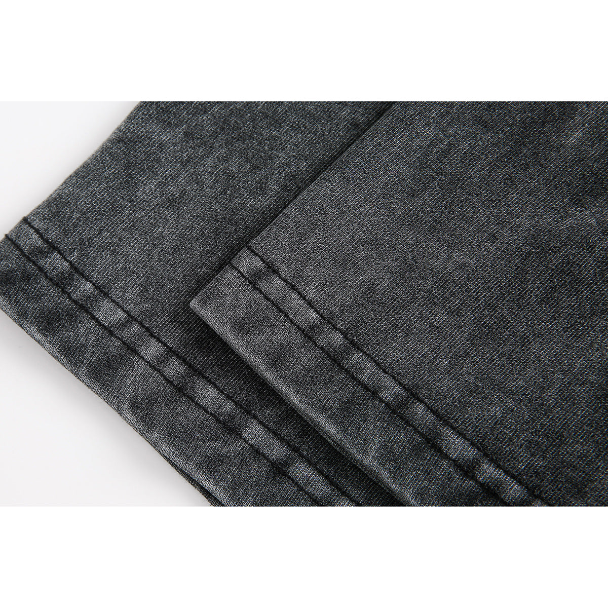 Close-up of the charcoal gray T-shirt fabric and double-stitched hem.