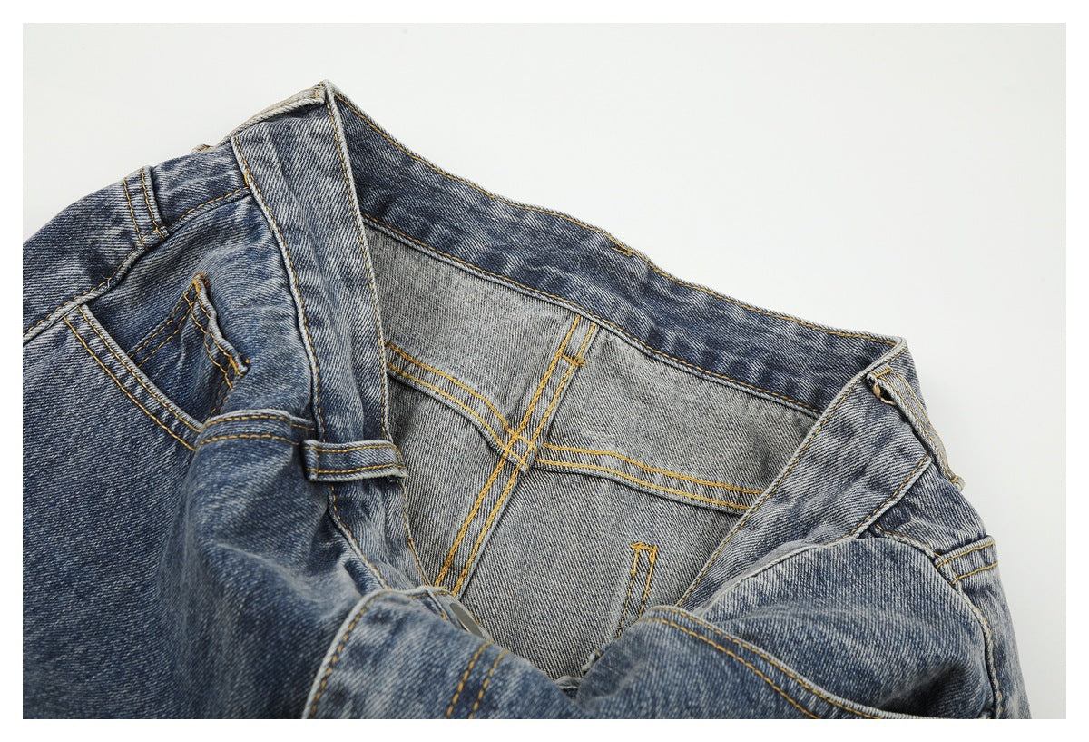 Close-up of the inside waistband and fly area of blue jeans, showing contrast stitching.