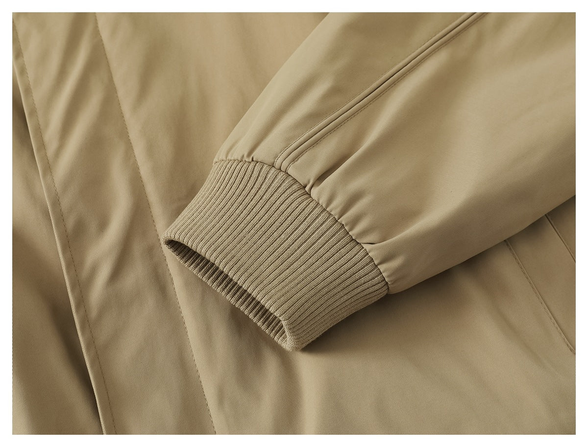 Close-up of the tan jacket's sleeve ending in a wide ribbed cuff.