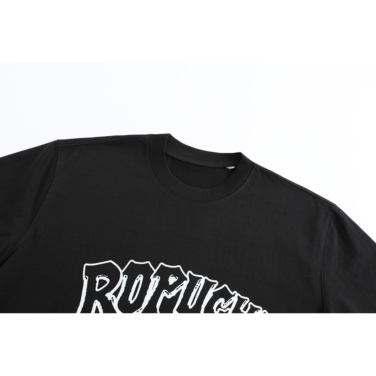 Close-up of a black crew-neck T-shirt front with part of a large white outlined graphic.