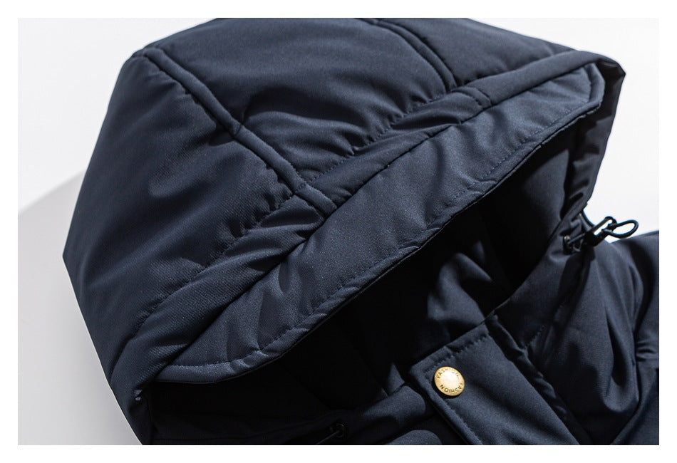 Close-up of the padded navy jacket hood, edge stitching, and a snap button.
