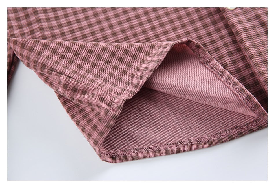 Close-up of the shirt's folded hem, showing the checked outer fabric and stitched underside.