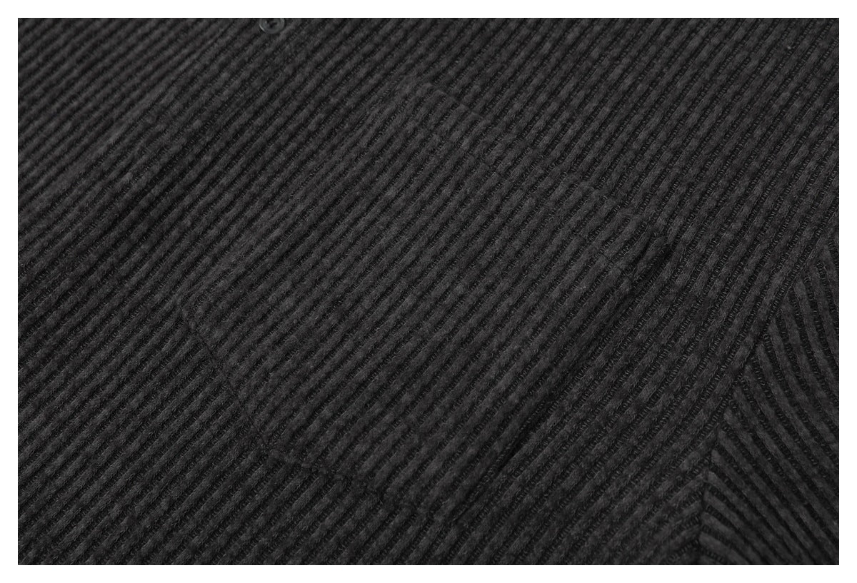 Close-up of the dark charcoal shirt's ribbed fabric and a seam.