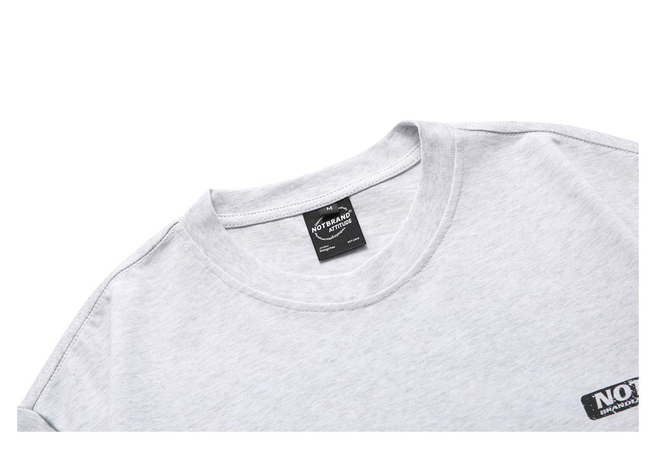 Close-up of a light gray heather T-shirt crew neckline, shoulder seam, and neck label.