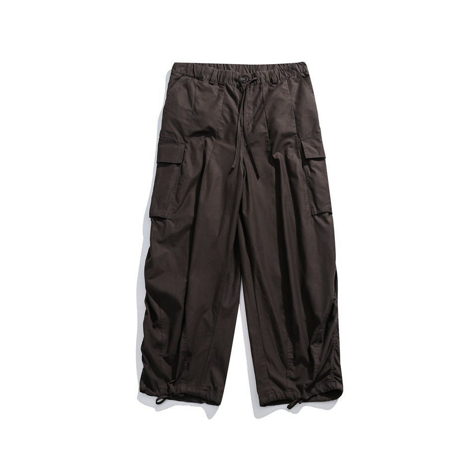 Brown wide-leg cargo pants flat lay with drawstring waist, large side flap pockets and gathered hems
