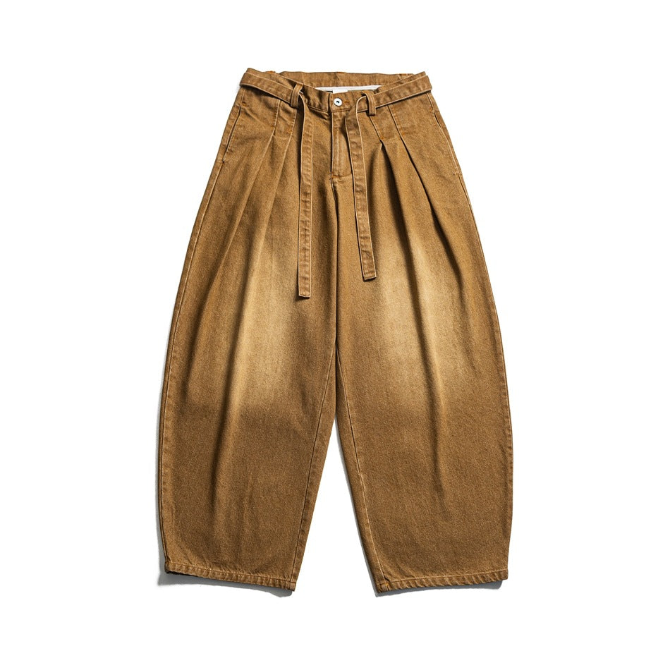 Brown faded wide-leg pleated jeans with a tie belt, flat lay front view