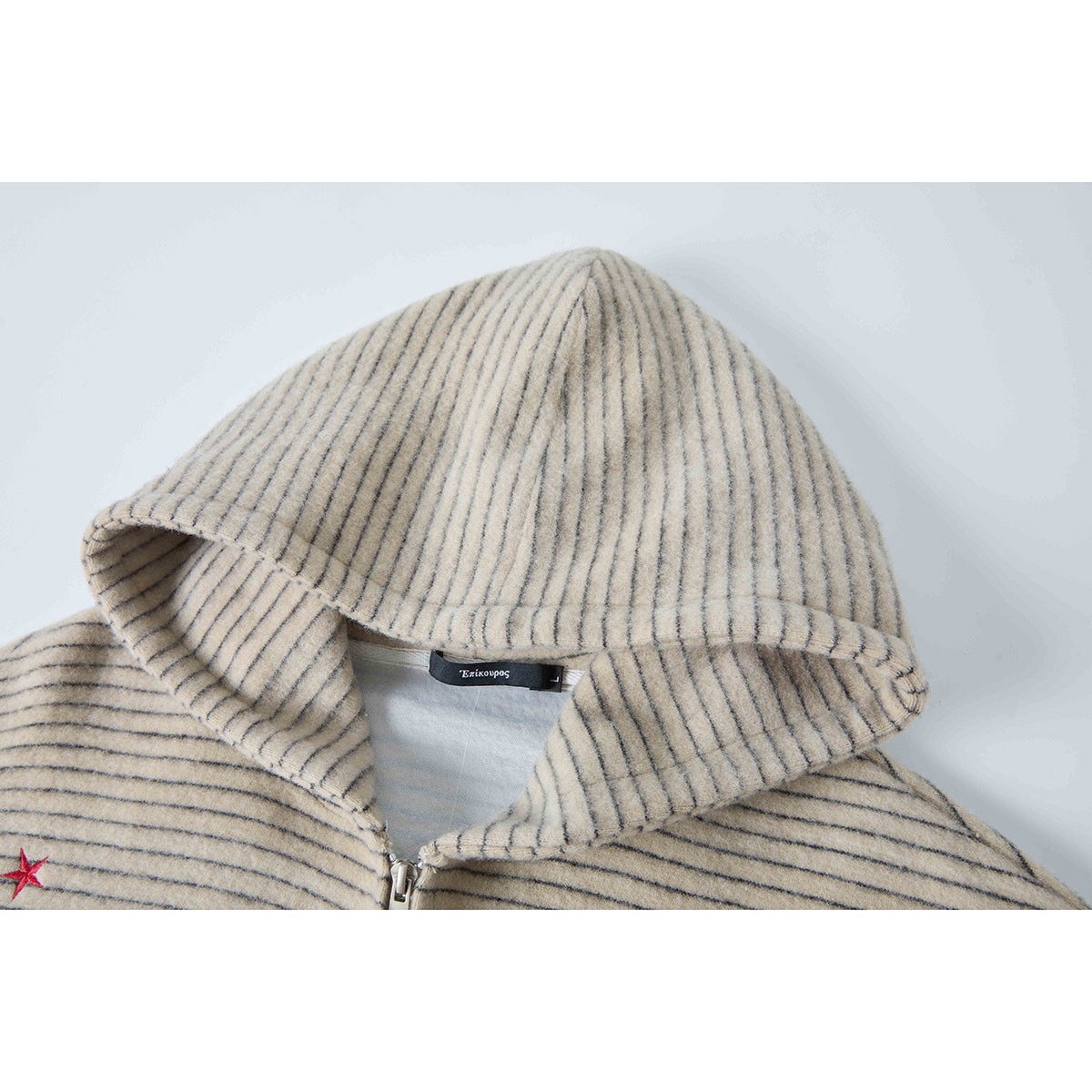 Close-up of a beige hooded jacket with thin gray stripes, showing the hood, zipper, and neck label.
