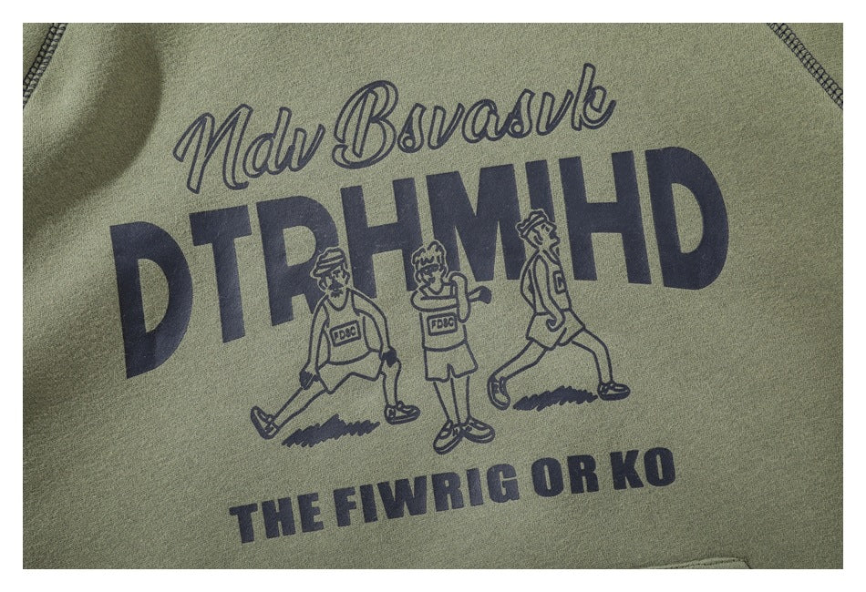 Close-up of an olive green hoodie with a dark graphic print of lettering and three figures.
