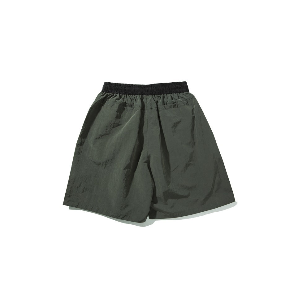 Dark olive shorts shown from the back, with a wide black elastic waistband and two rear pockets.