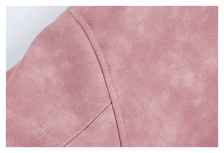 Close-up of a dusty rose jacket shoulder seam and curved panel stitching.