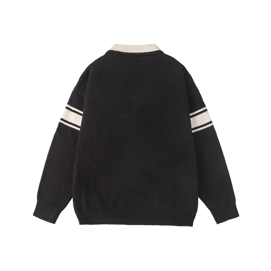 Back view of a black sweater with an ivory collar and ivory sleeve stripes, plus ribbed cuffs and hem.