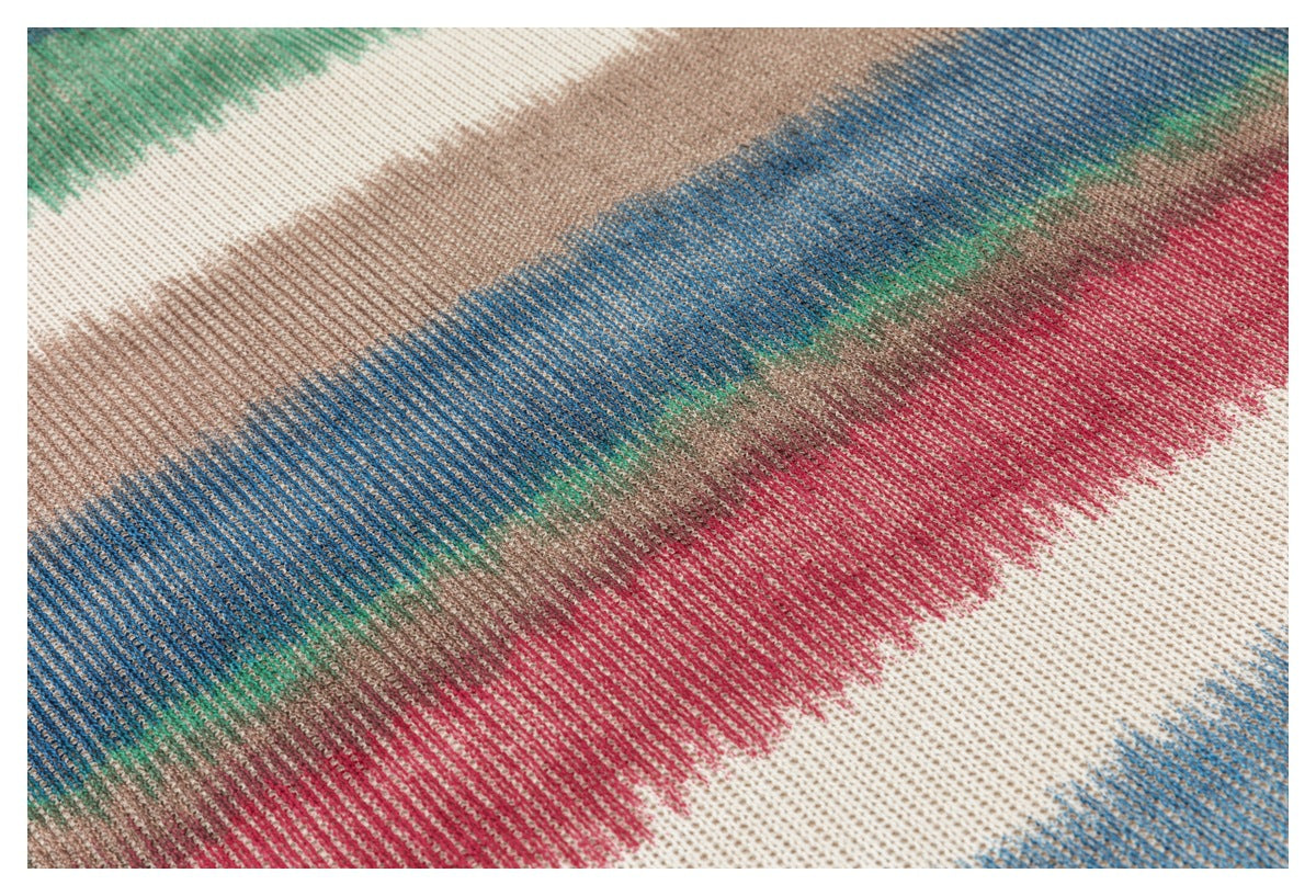 Close-up of the knit fabric, showing irregular bands of green, cream, tan, blue, and red.