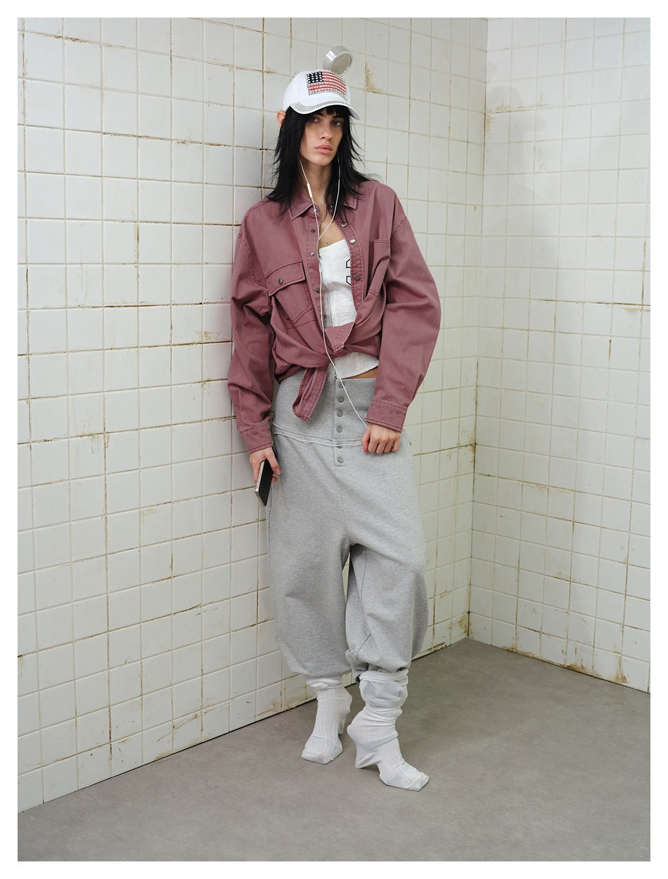 Full-length model wearing a dusty mauve snap-front overshirt with flap chest pockets, shown from the front.