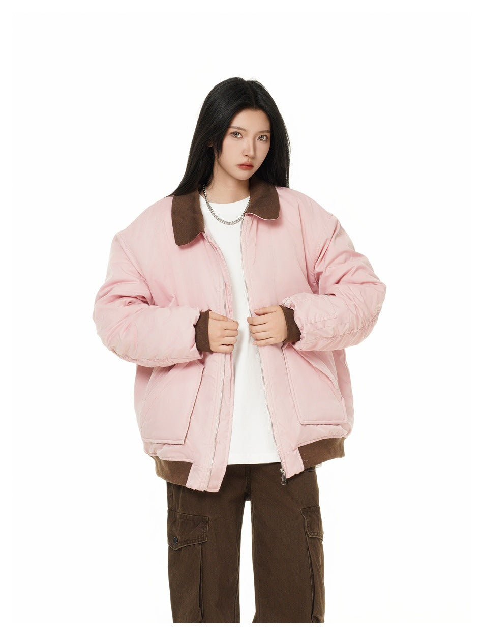 Model wearing an open pale pink jacket with a dark brown collar and cuffs, white top and brown cargo pants.