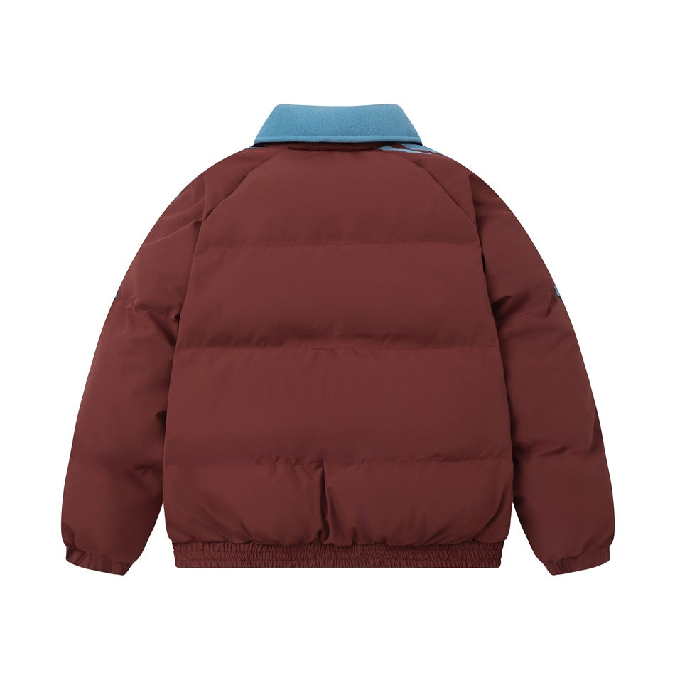 Back view of a burgundy quilted jacket with a bright blue collar and an elastic hem.