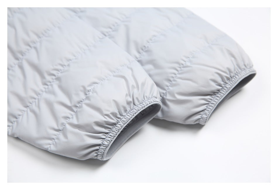 Close-up of elasticized cuffs on a light gray quilted jacket.