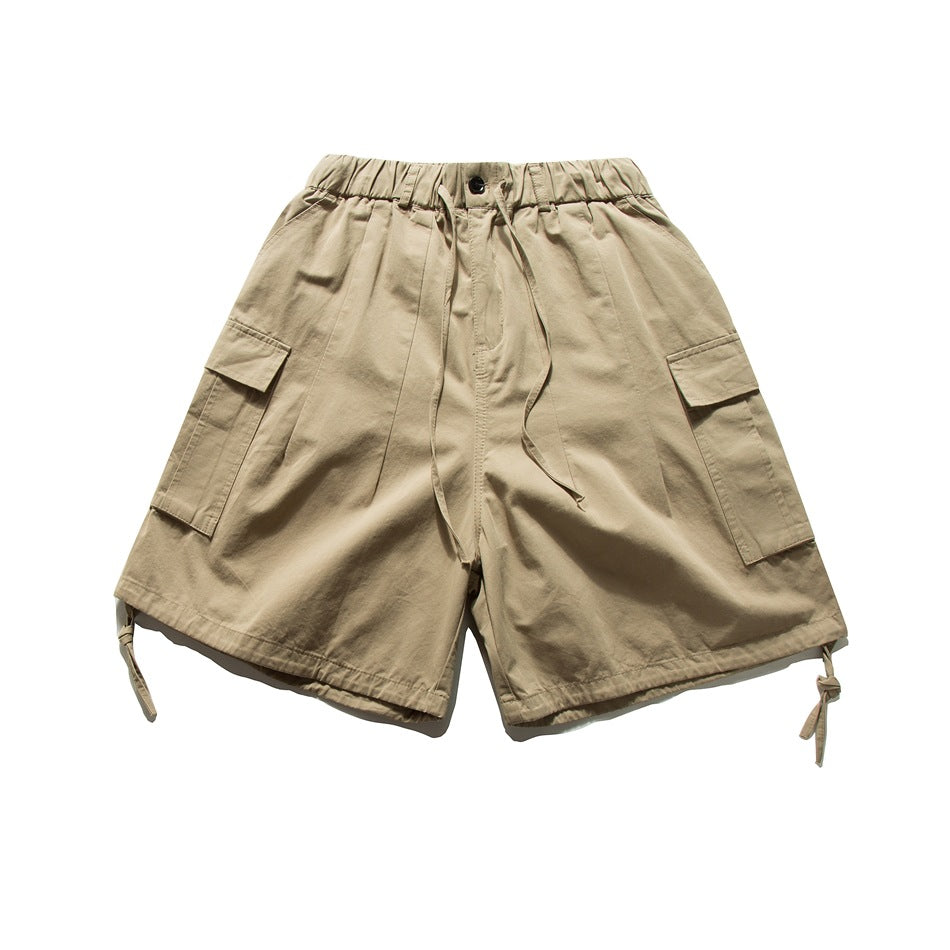 Khaki cargo shorts with elastic drawstring waist, side flap pockets and hem drawcord ties, flat lay front view