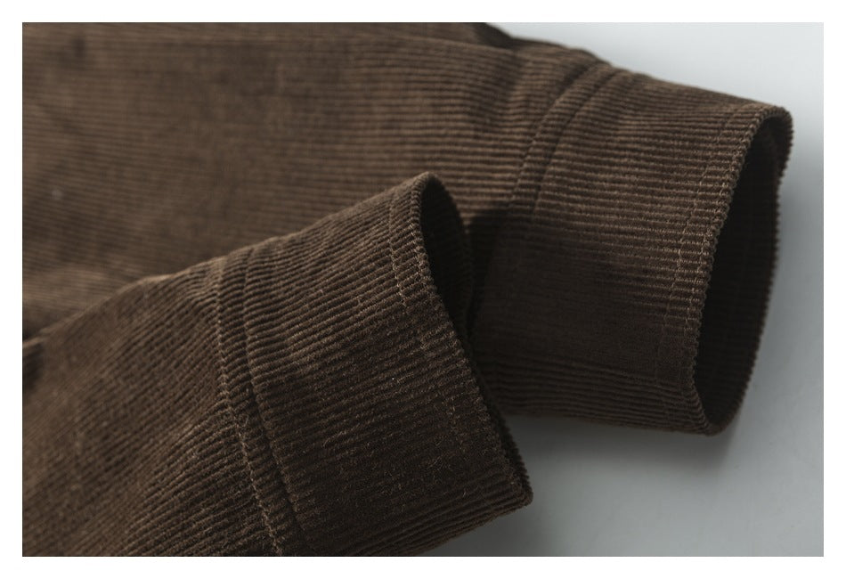Close-up of a folded cuff on brown corduroy, showing the ribbed texture and stitching.