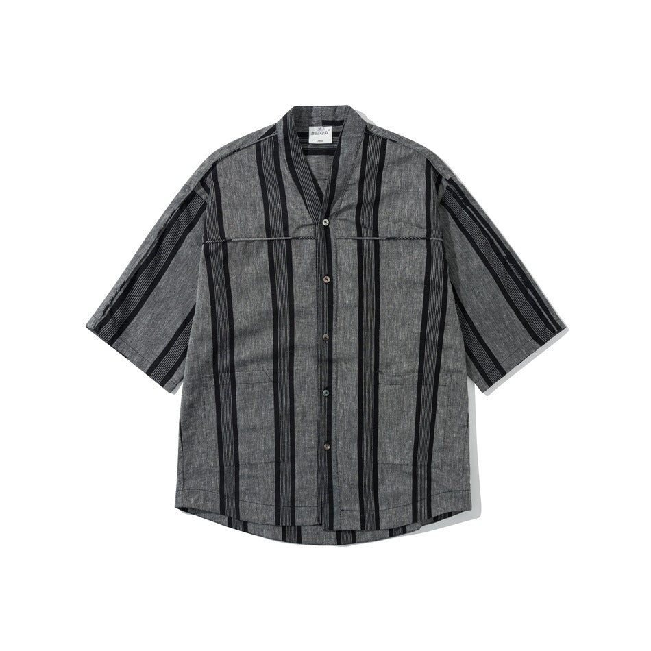 Charcoal gray shirt with black vertical stripes, V-neck, button front and two lower patch pockets, laid flat