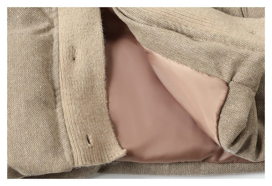 Jacket interior close-up showing beige woven fabric, buttonholes, and smooth dusty-rose lining.