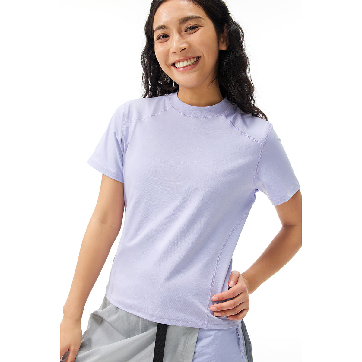 Close view of a model wearing a plain lavender short-sleeve crew-neck T-shirt with visible seam detailing.