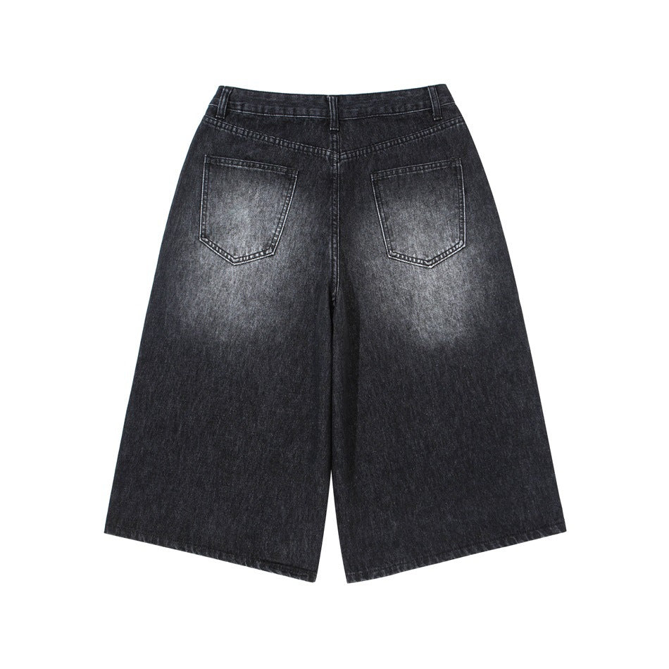 Back view of black wide-leg denim shorts with two rear pockets and subtle fading.