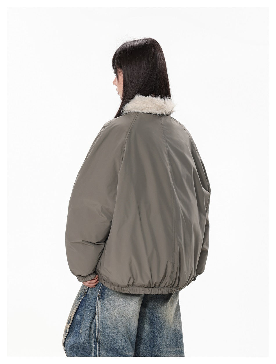 Rear view of a woman wearing a loose taupe bomber jacket with a cream faux-fur collar and elasticated hem.