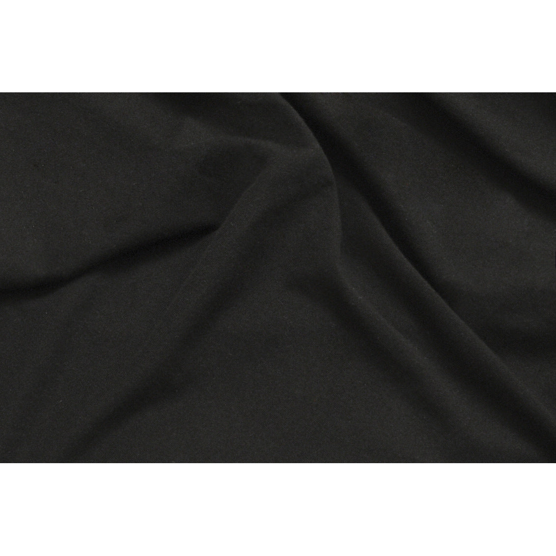 Close-up of plain black fabric draped into soft folds.