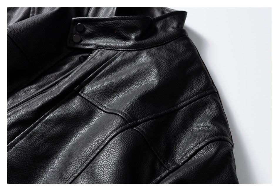 Close-up of a black pebbled jacket collar, snap buttons, and stitched panels.