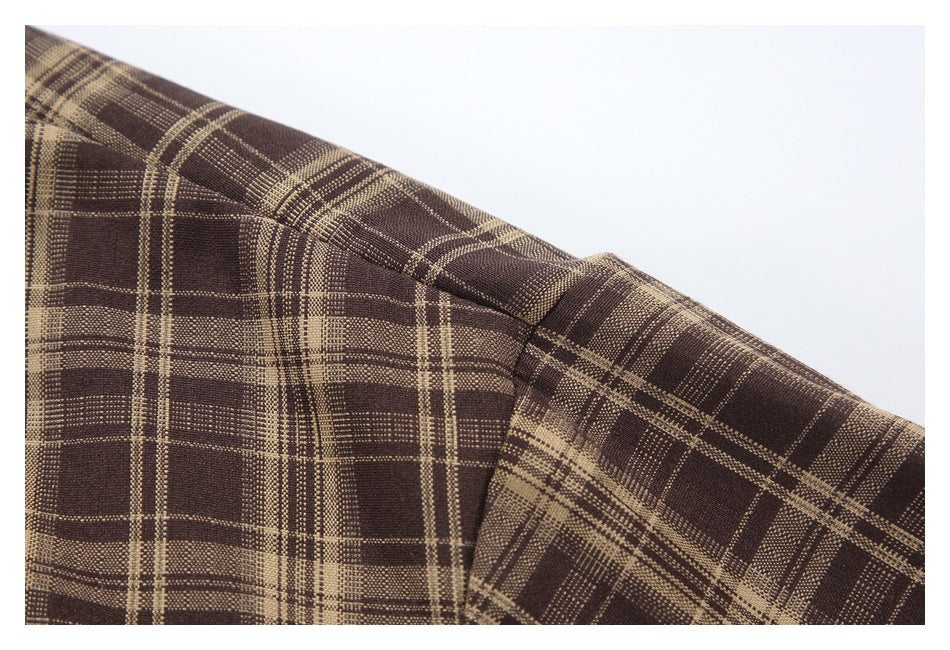 Close-up of the brown plaid jacket's shoulder seam and sleeve construction.